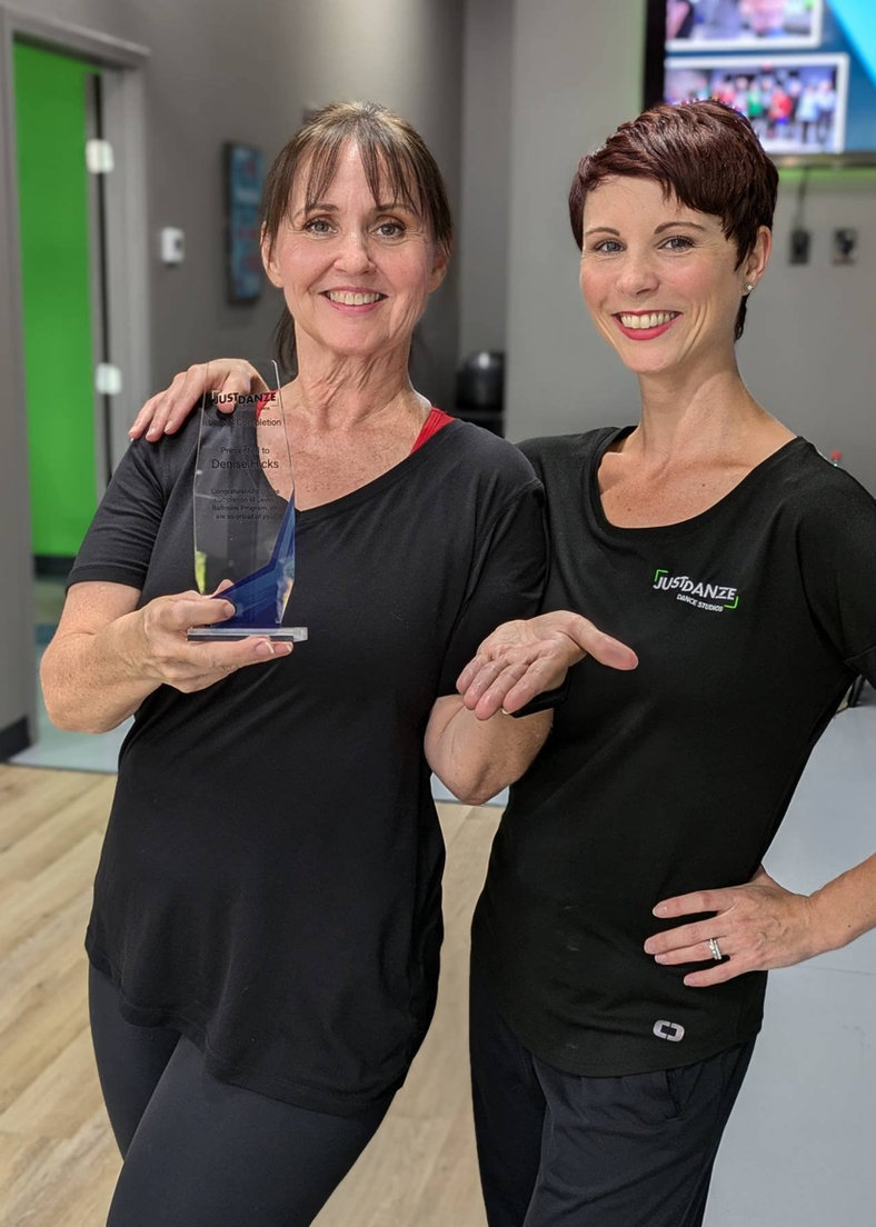 Denise receiving her Level 1 ballroom dancing award with instructor Trish