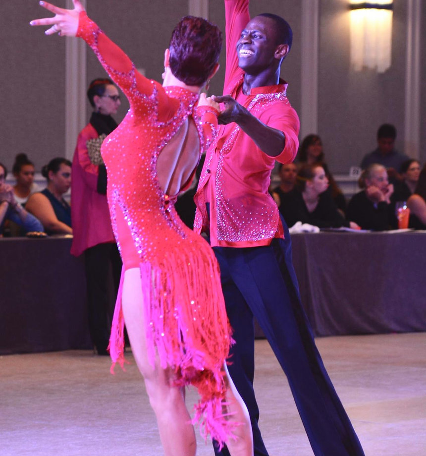 Adult couple in ballroom hold, mid-waltz, at Just Danze Dance Studios in Spring, TX